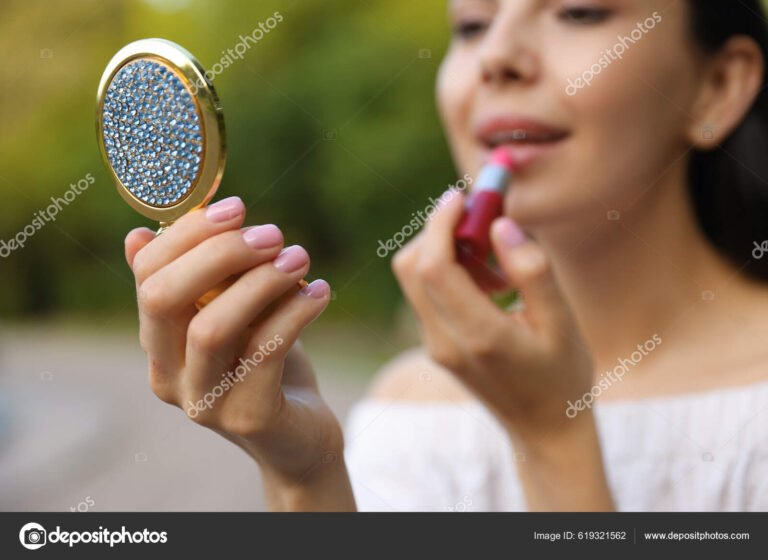 mujer probandose labiales frente al espejo